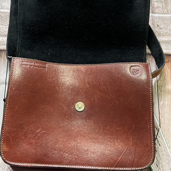 brown leather and features the gold-toned horsebit hardware.  B36 - Picture 5 of 9